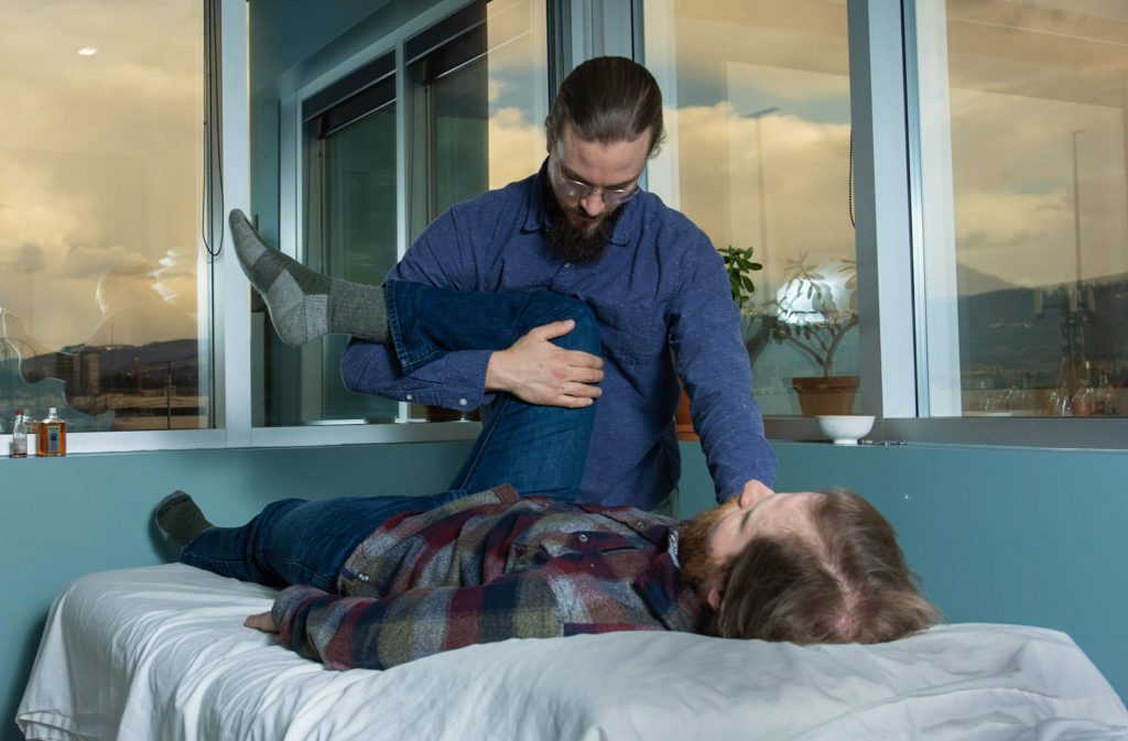 professional performing therapeutic massage on a client