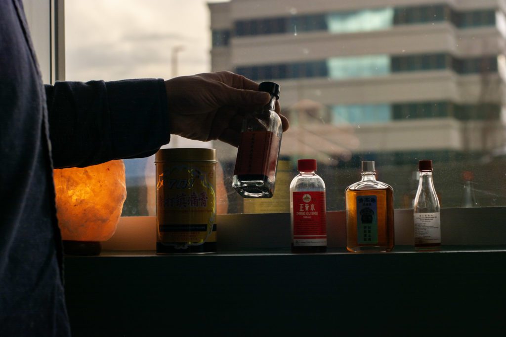 Chinese herbal medicine bottles on a windowsill