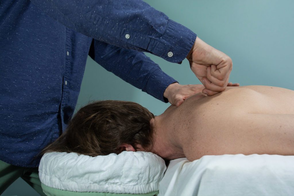 professional performing guasha on a client's back